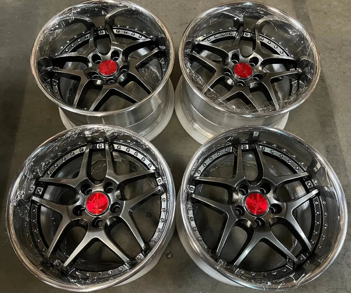 18-inch GMR Evoke alloy wheels — 5x100 bolt pattern, Titan Black finish, reverse offset design